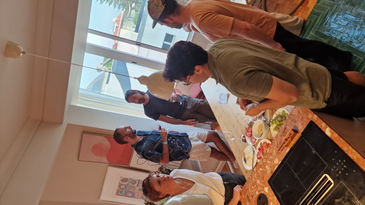 Guests cooking together at the Collaborative Cookout hosted by Chelsea Rustrum in Lisbon