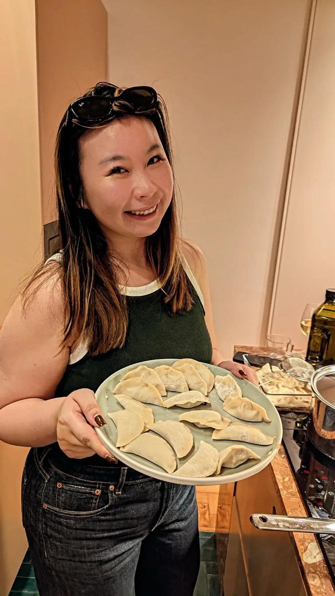 Guest holding a plate of finished dumplings at the Dumplings & AI dinner in Lisbon