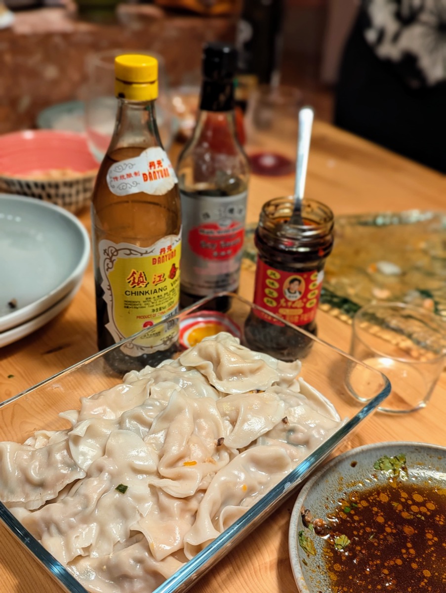 Tray of handmade dumplings with sauces at the Dumplings & AI dinner