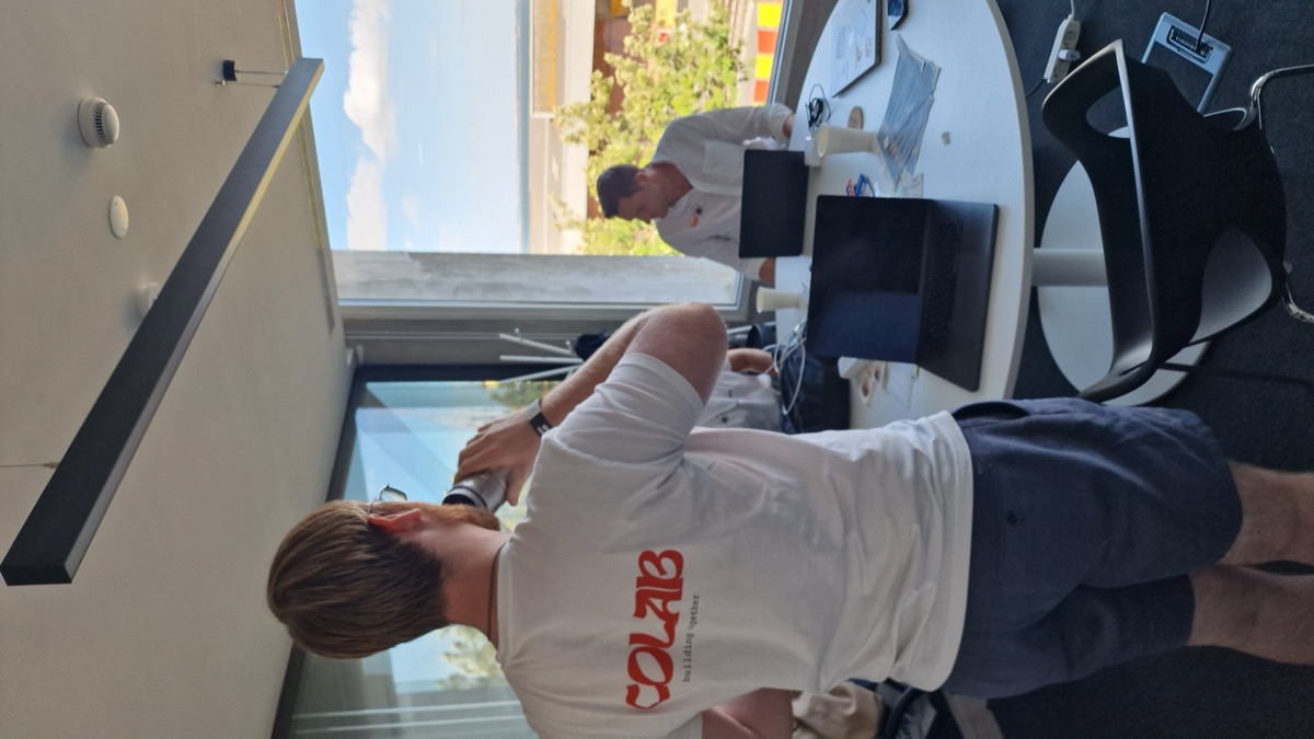 Builder in a CoLab shirt during the Vibe-a-thon hackathon