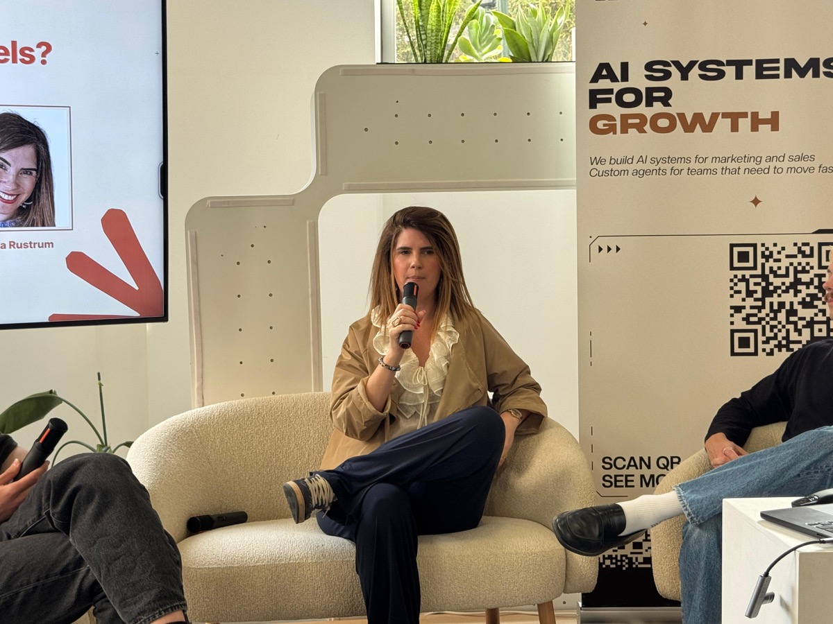 Chelsea Rustrum speaking on an AI panel in Lisbon